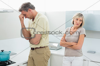 Angry couple after a fight in kitchen