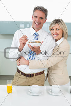 Loving couple having breakfast in kitchen