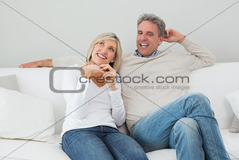 Happy couple sitting in the living room