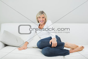 Portrait of a happy woman on sofa at home