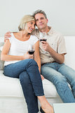 Relaxed couple with wine glasses at home