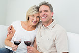 Happy couple with wine glasses at home