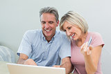 Couple doing online shopping at home