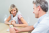 Woman and man playing cards at home