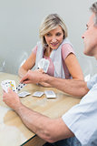 Woman and man playing cards at home