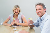 Couple with lime juices while playing cards at home