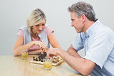 Couple playing chess at home