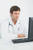 Male doctor using computer at medical office