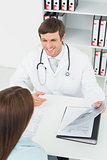 Doctor in conversation with female patient in medical office