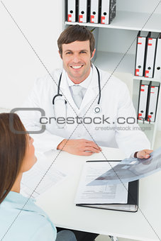 Doctor in conversation with female patient at medical office