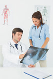 Doctors examining x-ray in medical office