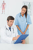 Doctors discussing reports in a medical office