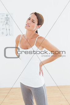 Beautiful young woman with back pain