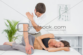 Male physiotherapist massaging woman's body