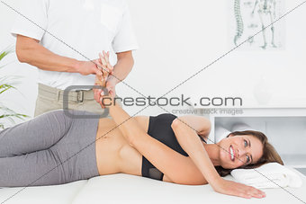 Doctor examining a patient's hand in medical office