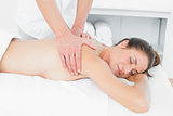 Close-up of male physiotherapist massaging woman's back