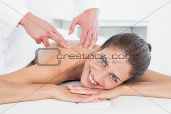 Male physiotherapist massaging woman's back