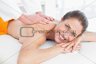 Male physiotherapist massaging woman's back