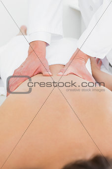 Close-up of a physiotherapist massaging woman's back