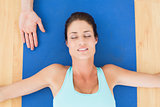 Woman relaxing with eyes closed at hospital gym