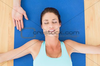 Woman relaxing with eyes closed at hospital gym