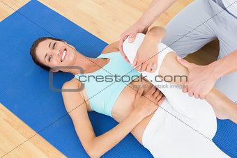 Physical therapist examining a happy woman's leg