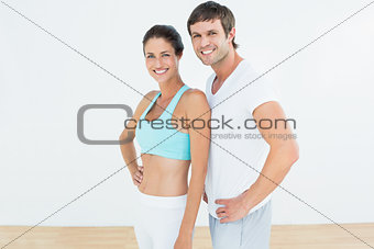 Portrait of a fit couple in fitness studio