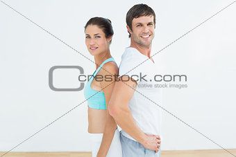 Portrait of a fit couple in fitness studio