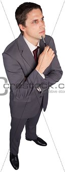 Thinking businessman holding pen
