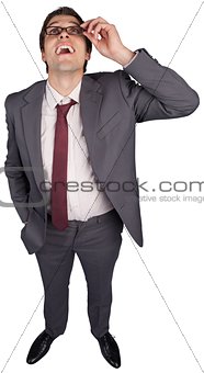 Thinking businessman touching his glasses