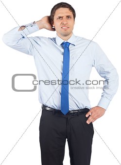 Thinking businessman scratching head