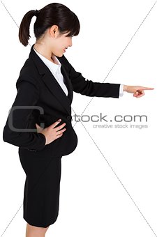 Smiling businesswoman pointing