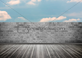Blue sky over a grey wall