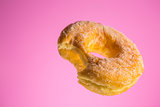 Sugar coated donut with bite mark