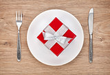 Valentine's day gift box on plate and silverware