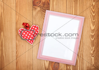 Blank photo frame and red Valentine's day heart toy