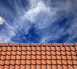 Roof tiles and sky with clouds at sun day