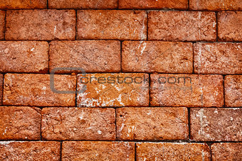 Wall of old red brick close up - background