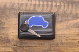 car keys and documents on dark wooden background 