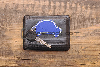 car keys and documents on dark wooden background 