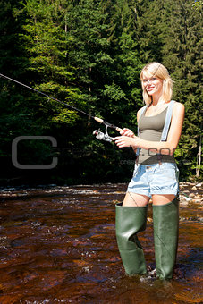 woman fishing in Jizera river, Czech Republic