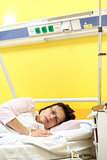 sad middle-aged woman lying in hospital