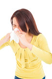 young woman using a tissue and blowing nose