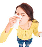 Young woman having  allergy and  blowing into tissue
