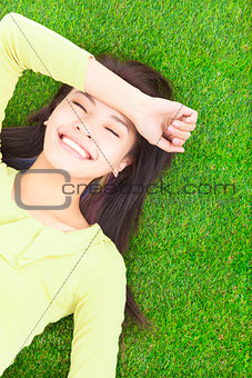 High angle view of a young woman resting on grass