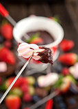 Marshmallow dipped in chocolate fondue