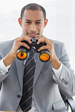 Portrait of a confident businessman with binoculars