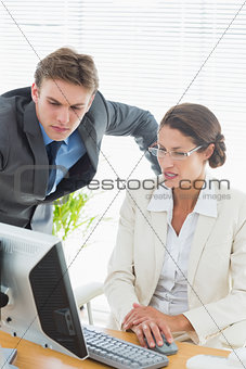 Smartly dressed business couple using computer