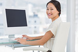 Young businesswoman using computer in office