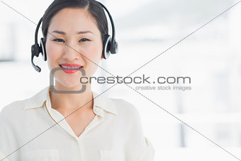 Beautiful smiling female executive with headset